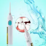 Rechargeable oral irrigator being used along the gumline